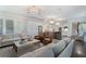 Open-concept living area with contemporary decor, seamlessly connecting the kitchen, dining, and lounge areas at 6805 Bucks Rd, Cumming, GA 30040