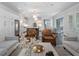 Bright, open-concept living area with modern furnishings seamlessly flowing into the kitchen and dining spaces at 6805 Bucks Rd, Cumming, GA 30040