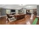 Inviting living room with hardwood floors, a leather sofa, and a brick accent wall at 6805 Bucks Rd, Cumming, GA 30040