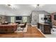Open-concept living area features exposed brick, modern lighting, and a cozy seating area, ideal for relaxing and entertaining guests at 6805 Bucks Rd, Cumming, GA 30040