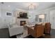 Cozy living room featuring a fireplace, built-ins, and comfortable seating arrangement for relaxation and entertainment at 6805 Bucks Rd, Cumming, GA 30040
