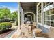 Covered patio featuring stone flooring, cozy seating, and a view of the backyard and outdoor living area at 6805 Bucks Rd, Cumming, GA 30040
