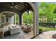 Inviting outdoor patio features comfortable seating, a cozy fire pit, and a ceiling fan, perfect for relaxation at 6805 Bucks Rd, Cumming, GA 30040