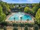Aerial view of a luxurious outdoor pool surrounded by lounge chairs and palm trees at 6805 Bucks Rd, Cumming, GA 30040