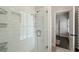 Beautiful walk-in shower features glass doors and white tiled walls and built in shelving at 6805 Bucks Rd, Cumming, GA 30040
