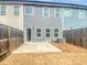Backyard view with a patio, grass, and a wooden fence surrounding the space at 7119 Gladstone Cir, Lithonia, GA 30038