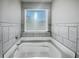 Close up of tiled bath tub under a window at 7119 Gladstone Cir, Lithonia, GA 30038