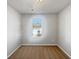 A simple, well-lit bedroom with neutral walls, carpet, and a window at 7119 Gladstone Cir, Lithonia, GA 30038