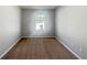 Neutral bedroom with light gray walls and brown carpet, illuminated by natural light from a window at 7119 Gladstone Cir, Lithonia, GA 30038