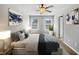 Well-lit bedroom with neutral walls, carpet, two windows, and modern decor for a comfortable living space at 7119 Gladstone Cir, Lithonia, GA 30038