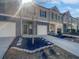 Street view of modern townhomes showcasing gray exterior, private garages, and small front yards at 7119 Gladstone Cir, Lithonia, GA 30038