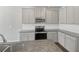 Close up view of a modern kitchen with stainless steel appliances and granite countertops at 7119 Gladstone Cir, Lithonia, GA 30038