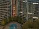 Aerial view of luxury high-rise apartments with a stunning swimming pool and city skyline at 950 W Peachtree Nw St # 1214, Atlanta, GA 30309