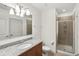 Bathroom featuring a single vanity with granite countertop and a glass-enclosed shower at 950 W Peachtree Nw St # 1214, Atlanta, GA 30309