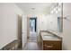 Modern bathroom with double vanity, granite countertops, and views into the bedroom at 950 W Peachtree Nw St # 1214, Atlanta, GA 30309