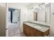 Modern bathroom with double vanity, granite countertops, and views into the bedroom and balcony at 950 W Peachtree Nw St # 1214, Atlanta, GA 30309