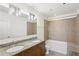 Bathroom with dual sinks, tile backsplash, and shower-tub combination at 950 W Peachtree Nw St # 1214, Atlanta, GA 30309