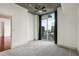 Bright bedroom featuring a balcony with city views, carpet, and neutral finishes at 950 W Peachtree Nw St # 1214, Atlanta, GA 30309