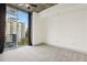 Bright bedroom featuring a large window with city views, carpet, and neutral finishes at 950 W Peachtree Nw St # 1214, Atlanta, GA 30309