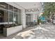 Exterior of the building featuring a covered entrance, modern architecture and outdoor seating area for residents and guests at 950 W Peachtree Nw St # 1214, Atlanta, GA 30309