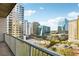 Condo balcony view showcasing the city skyline, with multiple commercial buildings, tree coverage and busy streets at 950 W Peachtree Nw St # 1214, Atlanta, GA 30309