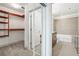 View of the bathroom and walk-in closet with custom shelving at 950 W Peachtree Nw St # 1214, Atlanta, GA 30309