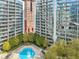 Exterior view of condo buildings overlooking a beautiful outdoor pool area with ample seating and well-maintained landscaping at 950 W Peachtree Nw St # 1214, Atlanta, GA 30309