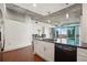 This kitchen features hardwood floors, white cabinets, stainless steel appliances, and an exterior view at 950 W Peachtree Nw St # 1214, Atlanta, GA 30309
