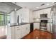 Kitchen features white cabinets, hardwood floors, stainless steel appliances and plenty of counter space for cooking at 950 W Peachtree Nw St # 1214, Atlanta, GA 30309