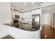 Modern kitchen with stainless steel appliances, island with granite countertop, and white cabinetry with great lighting at 950 W Peachtree Nw St # 1214, Atlanta, GA 30309