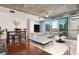Open-concept living room with hardwood floors, city views, dining table, and modern furniture at 950 W Peachtree Nw St # 1214, Atlanta, GA 30309