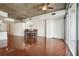 Living room with hardwood floors, large windows, dining table, and exposed concrete ceiling at 950 W Peachtree Nw St # 1214, Atlanta, GA 30309