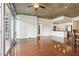 Spacious living room featuring hardwood floors, an exposed concrete ceiling, and a modern open kitchen concept at 950 W Peachtree Nw St # 1214, Atlanta, GA 30309
