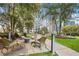 Inviting outdoor seating area with comfortable wicker furniture and lush landscaping with city views at 950 W Peachtree Nw St # 1214, Atlanta, GA 30309