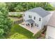 Aerial view of the home's backyard featuring a patio with outdoor seating and a spacious lawn at 100 Grove View Rd, Woodstock, GA 30189