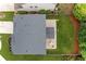 A stunning aerial view showcases the house, the verdant lawn, and the patio setup at 100 Grove View Rd, Woodstock, GA 30189