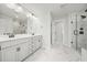 Spa-like bathroom boasts double sinks, modern fixtures, and a luxurious glass-enclosed shower at 100 Grove View Rd, Woodstock, GA 30189