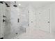 Elegant bathroom featuring a glass enclosed shower with marble tile and built in bench at 100 Grove View Rd, Woodstock, GA 30189