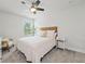 Cozy bedroom with natural light, neutral decor and comfortable bedding at 100 Grove View Rd, Woodstock, GA 30189