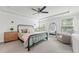 Serene bedroom retreat featuring tray ceiling, a stylish bed, and ample natural light at 100 Grove View Rd, Woodstock, GA 30189