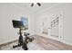 Bright room featuring a stationary bike, with wood floors and white trim at 100 Grove View Rd, Woodstock, GA 30189