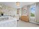 Bedroom featuring decor, crib, changing table, and chair with bright, natural light at 100 Grove View Rd, Woodstock, GA 30189