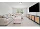 Bonus room with mounted television and stylish cabinet storage with comfortable seating at 100 Grove View Rd, Woodstock, GA 30189