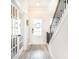Bright entryway featuring wood floors, white trim, and a decorative wreath on the front door at 100 Grove View Rd, Woodstock, GA 30189