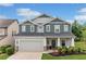 Beautiful two-story home featuring a manicured lawn and a two-car garage at 100 Grove View Rd, Woodstock, GA 30189