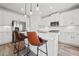 Spacious kitchen with white cabinets, stainless steel appliances, and a large island at 100 Grove View Rd, Woodstock, GA 30189
