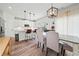 Stylish kitchen and dining area with pendant lighting, white cabinets, and modern finishes at 100 Grove View Rd, Woodstock, GA 30189