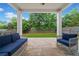 Covered patio featuring comfortable seating, a ceiling fan, and access to the green backyard at 100 Grove View Rd, Woodstock, GA 30189