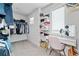 Well-organized walk-in closet with ample storage and dressing table with natural light at 100 Grove View Rd, Woodstock, GA 30189