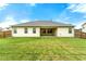 Home exterior overlooking a green lawn with a covered patio at 3700 Long Lake Dr, Douglasville, GA 30135